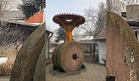 Alte Ölmühle aus einem großen Stein mit Holzrad